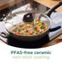 Non-stick grey frying pan with colourful stir-fry vegetables on kitchen hob