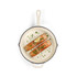 Cream cast iron frying pan with two cooked salmon fillets, lemon wedge and herbs