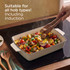 Roasting dish with cooked chicken and vegetables on a kitchen worktop
