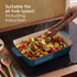 Ceramic baking dish with golden crumble topping on rustic wooden table