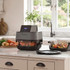 Salter grey air fryer oven on kitchen counter, cooking chicken with vegetables nearby