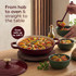 Red casserole dish with lid, filled with paella, shown on a hob with sliced chorizo beside