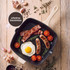 Cream cast iron grill pan with cooked salmon and asparagus on wooden board
