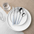 Table setting with silver cutlery and light blue handles on white plates