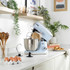 Blue stand mixer with stainless steel bowl and attachments on kitchen counter