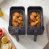 Dual basket air fryer with cooked fried chicken pieces