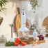 Light blue hand blender set with attachments on kitchen counter, surrounded by fresh vegetables