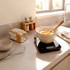 Kitchen scene with flour, mixing bowl and eggs on digital scale for baking preparation
