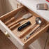 Black digital kitchen thermometer with utensils in open drawer