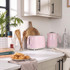 Pastel pink toaster and kettle set on kitchen counter