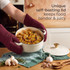 Cream cast iron casserole dish with lid on wooden kitchen surface