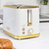 White ribbed electric kettle with gold accents shown on kitchen counter