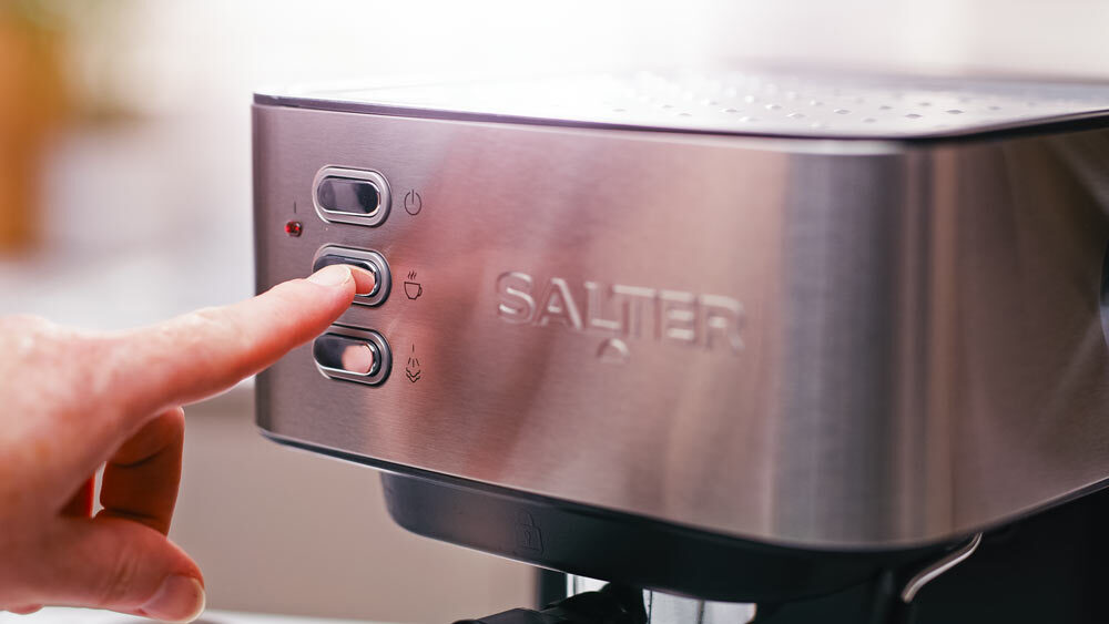 Pressing the brew button function on the salter manual espresso machine. 