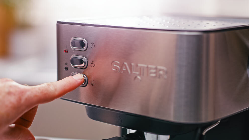 Pressing the steam function on the salter manual espresso machine. 