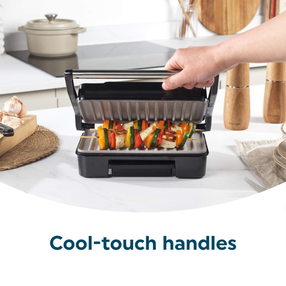 Open grey contact grill with vegetable skewers and cool-touch handle