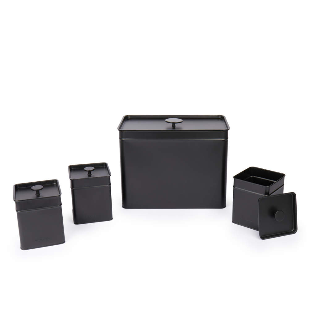 Set of four matte black metal kitchen storage tins with lids, shown in different sizes.