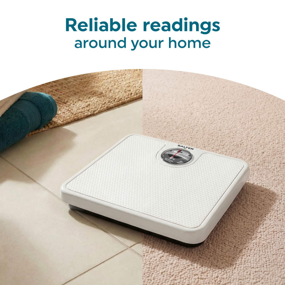 White bathroom scale on tiled and carpeted floor