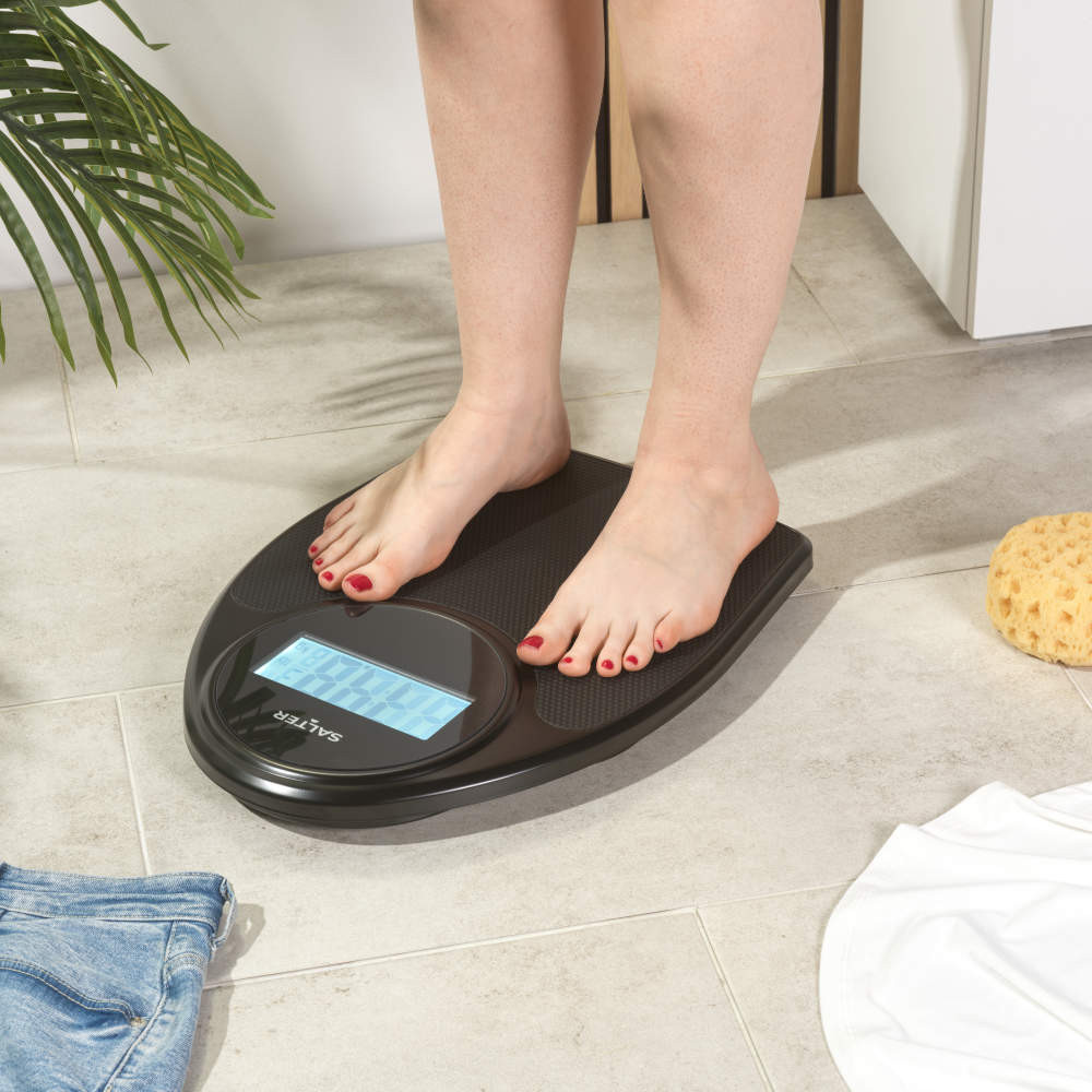 Black Salter digital bathroom scale with textured surface, angled view