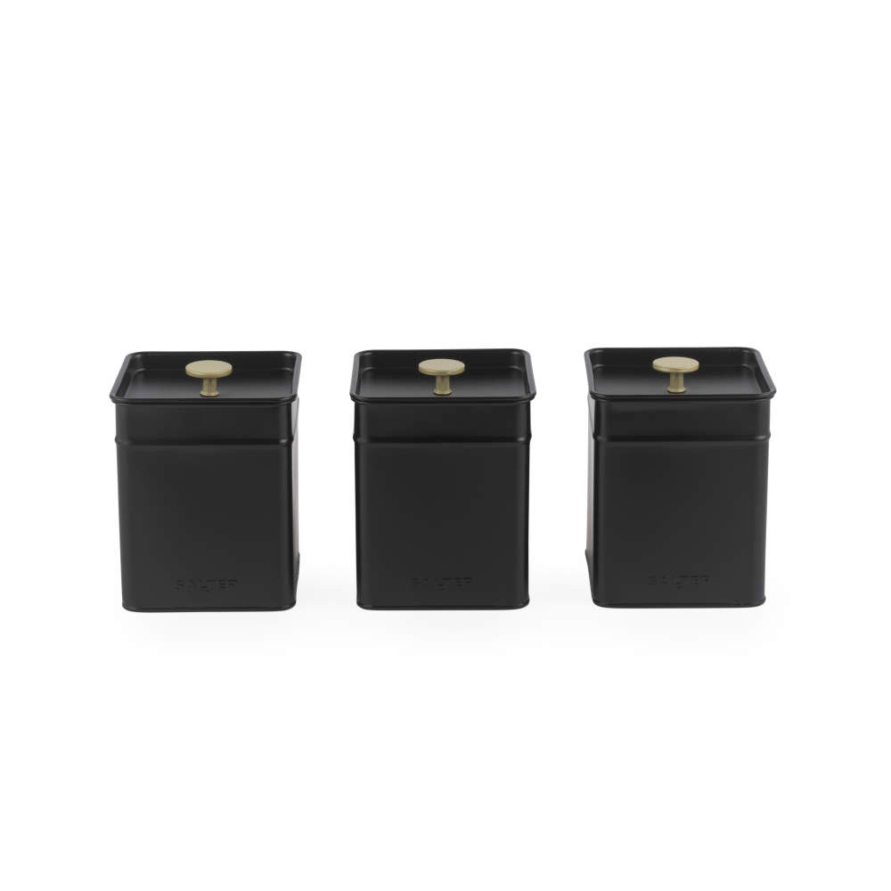 Set of three black metal storage canisters with gold knobs, front view.