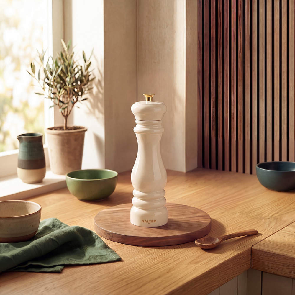 Cream pepper mill on wooden kitchen worktop
