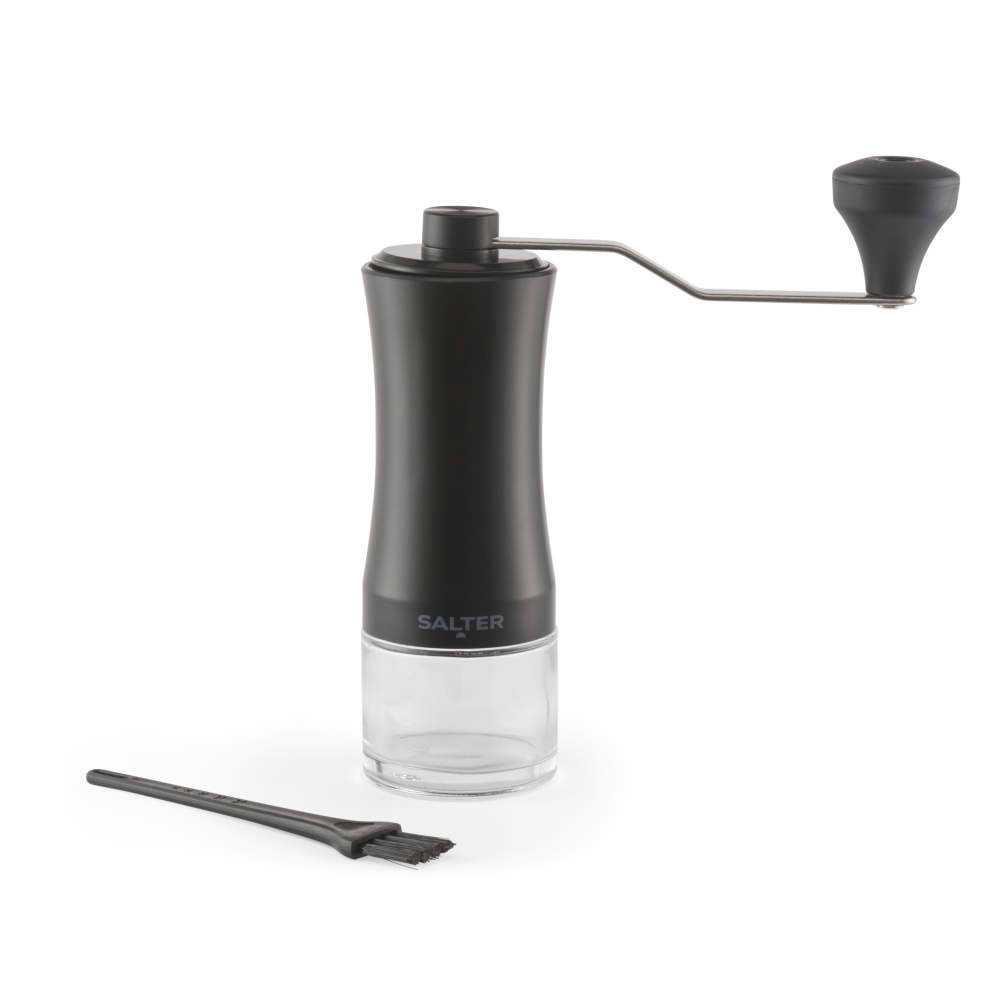 Black manual coffee grinder with glass base and cleaning brush