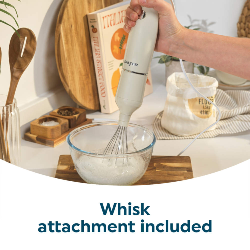 Cream hand blender with whisk attachment mixing in glass bowl