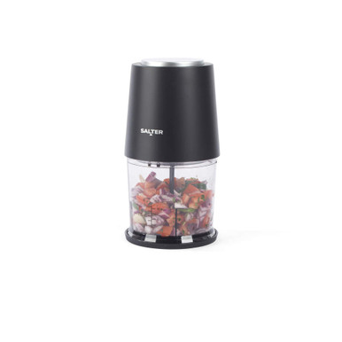 Black electric mini food chopper with clear bowl filled with chopped vegetables