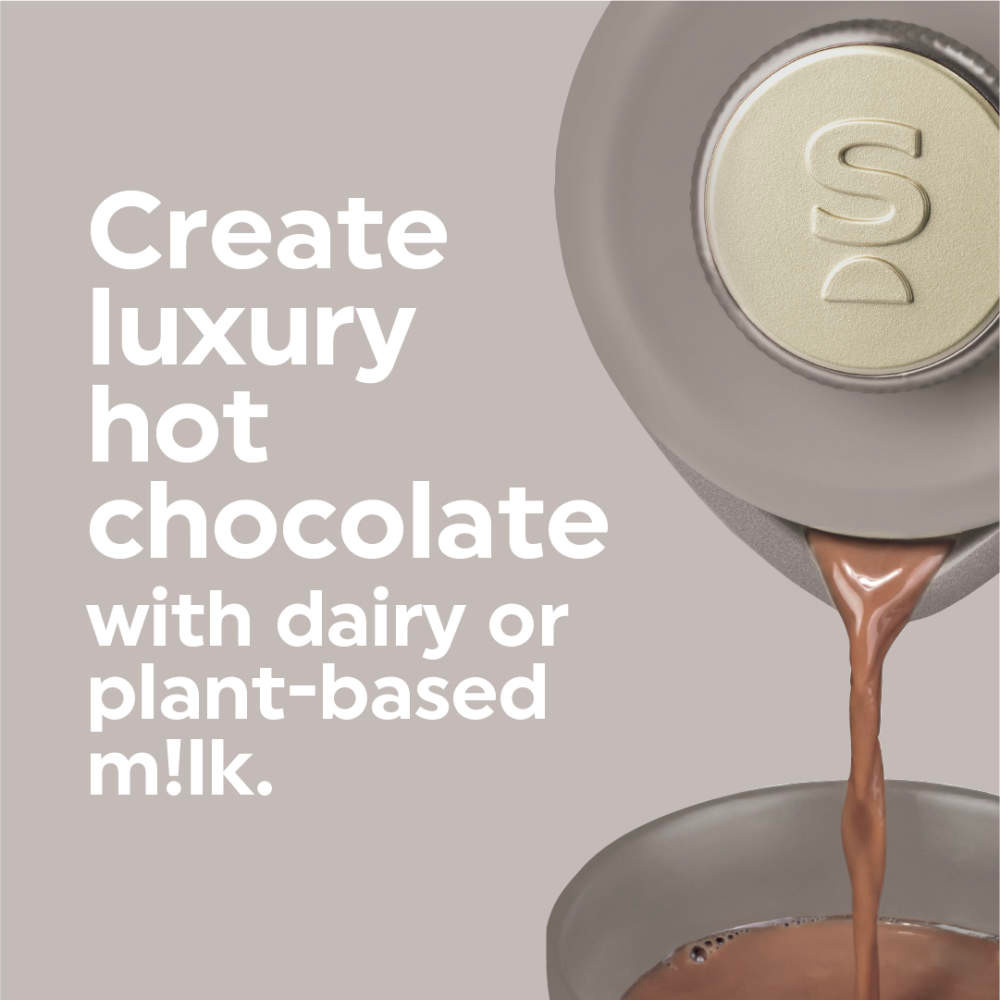 Hot chocolate maker pouring chocolate into a mug with text about dairy or plant-based milk