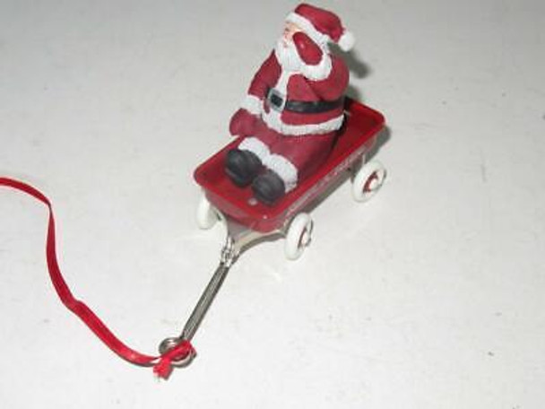 CHRISTMAS ORNAMENT - CERAMIC SANTA ON RADIO FLYER WAGON- GOOD - M4