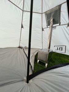 Explore the multi-purpose Backcountry Lite Tipi Tent Floor, showcased in this image with its zipper open and the floor carefully moved back to accommodate a camping stove. The picture perfectly captures the high-quality, rip-stop, waterproof fabric of this versatile outdoor gear, hinting at its ability to withstand challenging weather conditions while keeping you comfortable and dry. The reinforced tie-out points, visible in the corners, highlight its transformational ability to serve as a standalone tarp or shelter, making it a perfect companion for every adventure. The open zipper design further amplifies its utility, offering a safe and convenient space for a camping stove. This lightweight, packable, and easy-to-clean Backcountry Lite Tipi Tent Floor is not just an addition to your camping gear but a necessity for every outdoor enthusiast. Explore the multi-purpose Backcountry Lite Tipi Tent Floor, showcased in this image with its zipper open and the floor carefully moved back to accommodate a camping stove. The picture perfectly captures the high-quality, rip-stop, waterproof fabric of this versatile outdoor gear, hinting at its ability to withstand challenging weather conditions while keeping you comfortable and dry. The reinforced tie-out points, visible in the corners, highlight its transformational ability to serve as a standalone tarp or shelter, making it a perfect companion for every adventure. The open zipper design further amplifies its utility, offering a safe and convenient space for a camping stove. This lightweight, packable, and easy-to-clean Backcountry Lite Tipi Tent Floor is not just an addition to your camping gear but a necessity for every outdoor enthusiast.