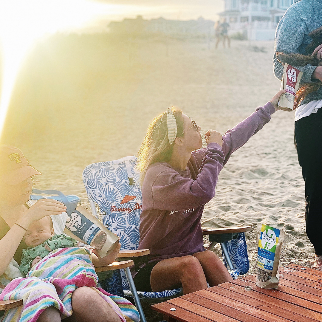 Family enjoying Granola Factory on the beach.