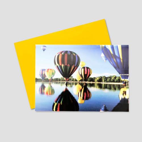 Employee Birthday greeting card featuring many colorful hot air balloons floating over a lake on a bright, sunny day