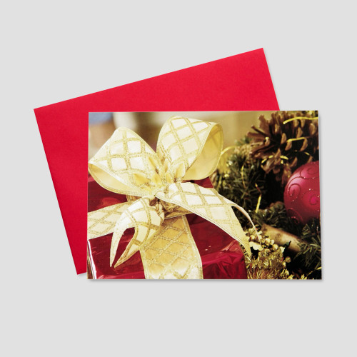 Corporate Christmas greeting card with a large present adorned in beautiful wrapping paper and a golden bow and surrounded by holiday elements