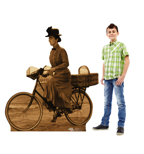 Life-size Miss Gulch on Bike - Wizard of Oz Cardboard Standup next to child