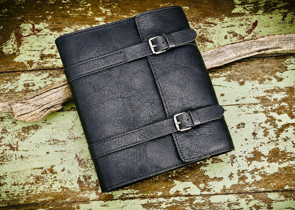 Handmade Black bison leather Bible cover with double straps and buckle closure, featuring natural grain texture and rustic full-grain finish.