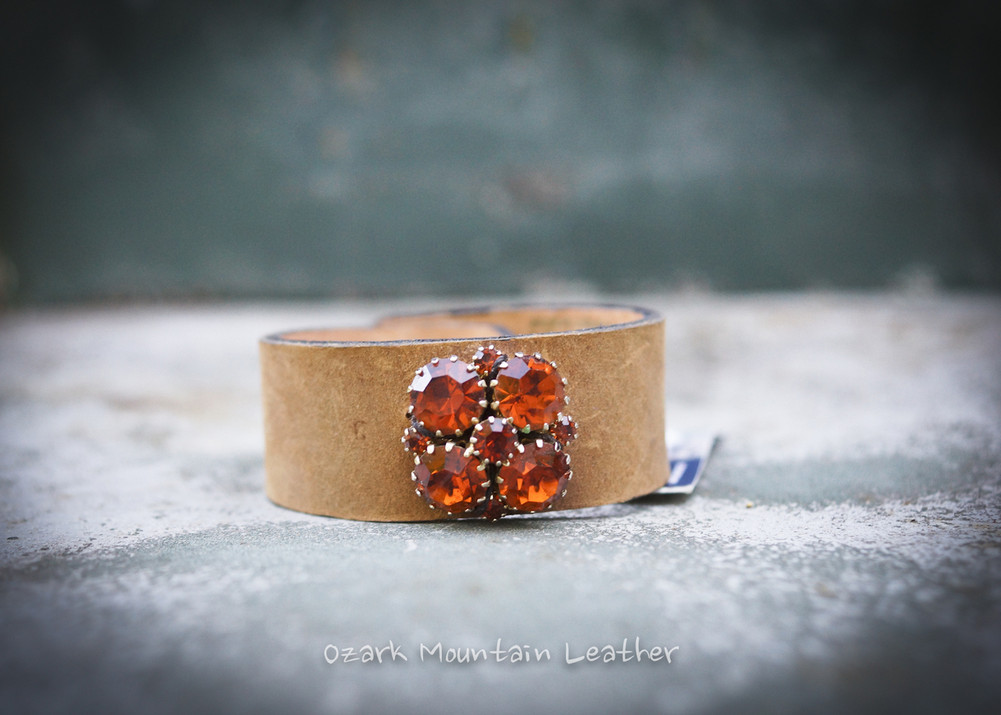 Vintage leather cuff with orange rhinestone on brown 