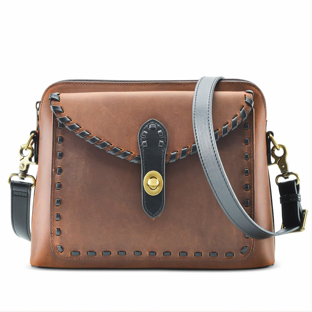 Conceal and carry bag in distressed bag made by Lady Conceal.  Full grain leather with a western laced detail.