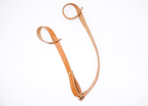 Handmade leather shotgun sling and rifle sling designed for firearms without swivels. This slip-on leather sling easily fits over the stock and barrel, providing a secure and comfortable carry option without the need for swivels or drilling into your gun. Crafted from premium Hermann Oak leather, it combines durability with classic style. Perfect for hunters, outdoorsmen, and shooters looking for a functional and traditional sling solution. Features a rugged slip-over design that protects your firearm while offering reliable support during long hunts or days in the field.