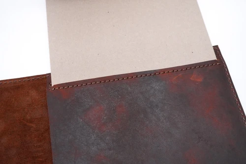 Interior view of our custom leather padfolio featuring a notepad holder, document pockets, business card slots, and a premium leather pen loop. Designed to keep meeting notes and important documents organized in one professional portfolio.

