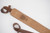 Example of a custom laser engraved message on the back of a handmade leather shotgun sling shoulder pad.
