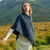 A200 303 Atlantic Blue Cable Aran Poncho With Button Detail Lifestyle Front View ExclusivelyIrish.com A200 303 Atlantic Blue Cable Aran Poncho With Button Detail Lifestyle Front View ExclusivelyIrish.com