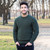 MM202 102 Army Green Mens Traditional Aran Crew Neck Sweater Lifestyle Front View ExclusivelyIrish.com