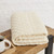 B888 001 WHITE Colour Authentic Irish Fisherman Blanket with Classic Patterns Folded View ShopAran.com