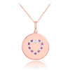 Heart disc pendant necklace with diamonds and rubies in 14k rose gold.