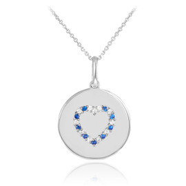 Heart disc pendant necklace with diamonds and sapphire in 14k white gold.