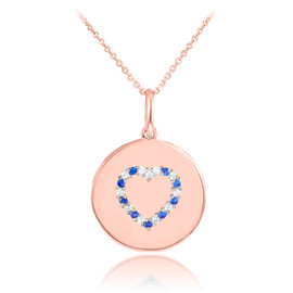 Heart disc pendant necklace with diamonds and sapphire in 14k rose gold.