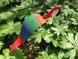 Red Macaw dancing garden art that moves with the wind atop a 35" stake, made in Michigan, USA.