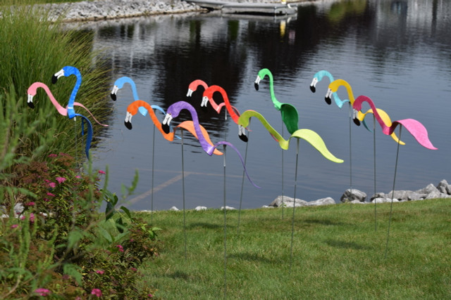 Flamingos dancing garden art that moves with the wind atop 35" stakes, made in Michigan, USA.