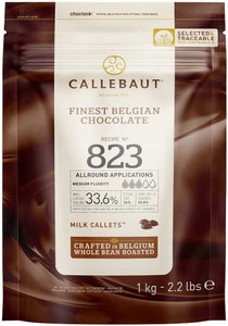 Front of Callebaut 823 Milk Callets 33.6% 1kg bag showing product branding, cocoa percentage, and usage details. Label highlights medium fluidity, allround applications, and that the chocolate is crafted in Belgium from whole bean roasted cocoa.