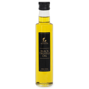 Bottle of Truffle Hunter Black Truffle Oil 250ml with black and gold label, filled with golden olive oil, displayed on a white background. Bottle of Truffle Hunter Black Truffle Oil 250ml with black and gold label, filled with golden olive oil, displayed on a white background.
